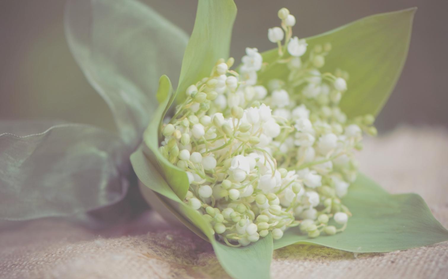 Elegant wedding centerpiece with white roses and eucalyptus arranged on reception table